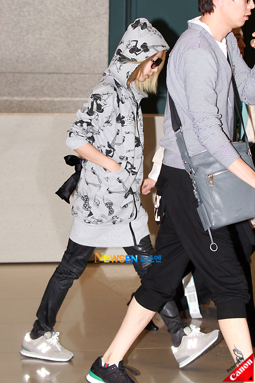 Boa hides in a long gray hoodie and matching new balance sneakers